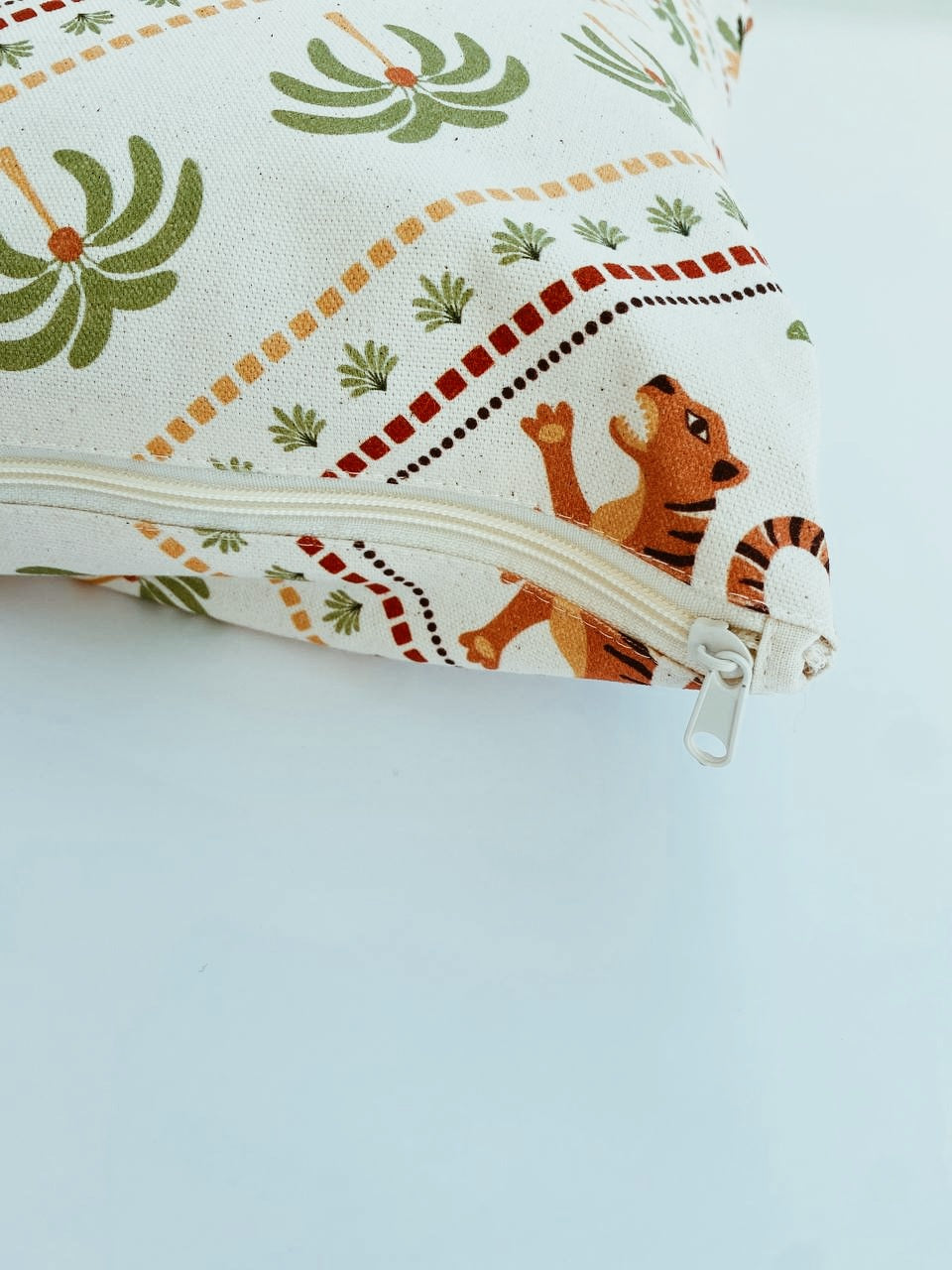 Fabric pouch with zipper featuring a tiger design on a light blue background