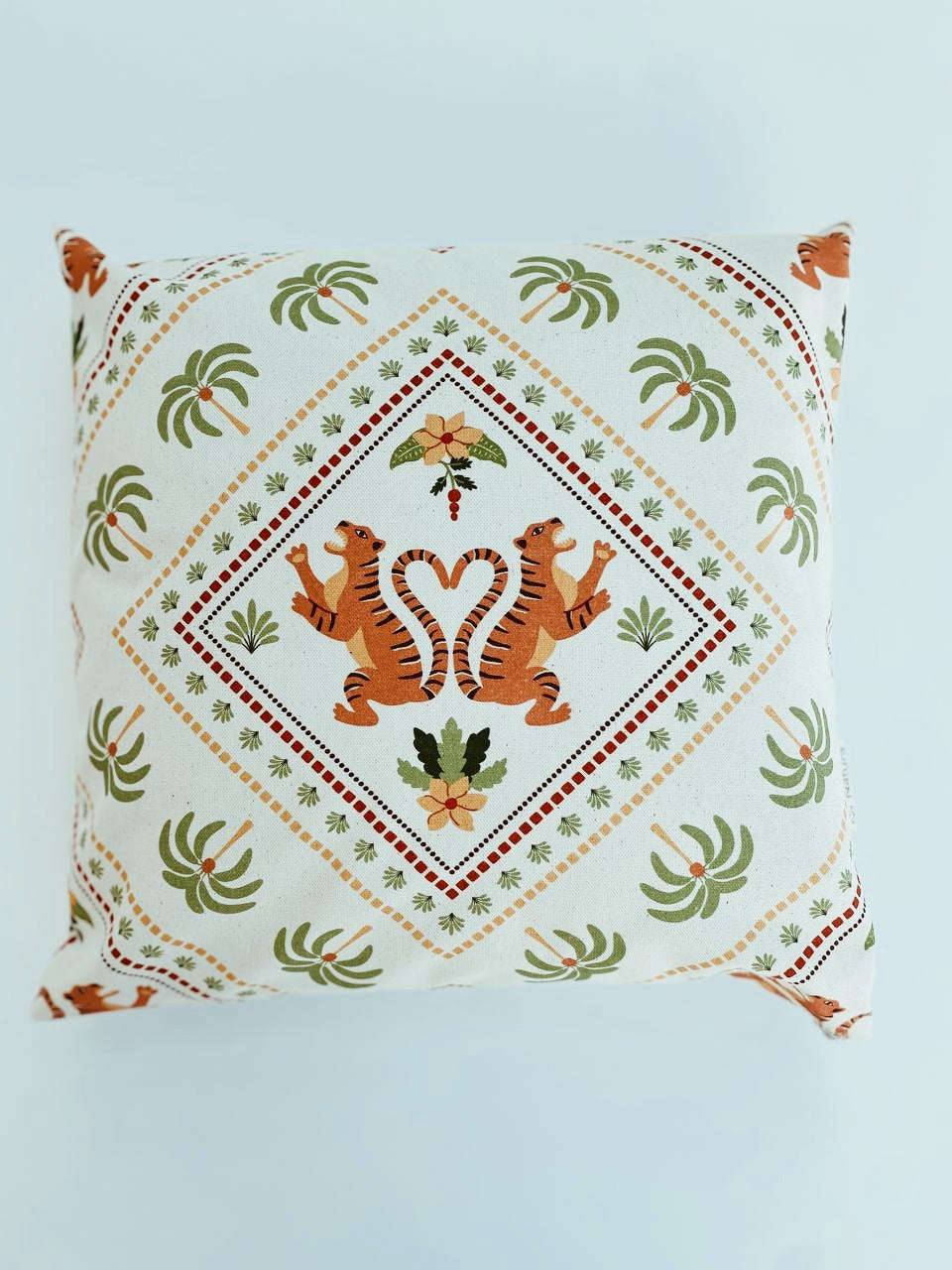 Decorative pillow with tiger design on a light blue background