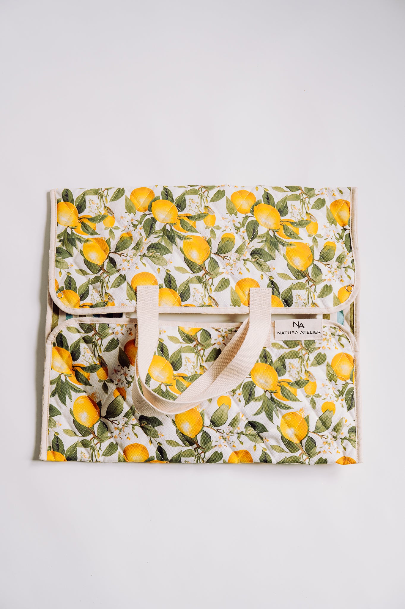 Floral-patterned bag with lemon design on a white background