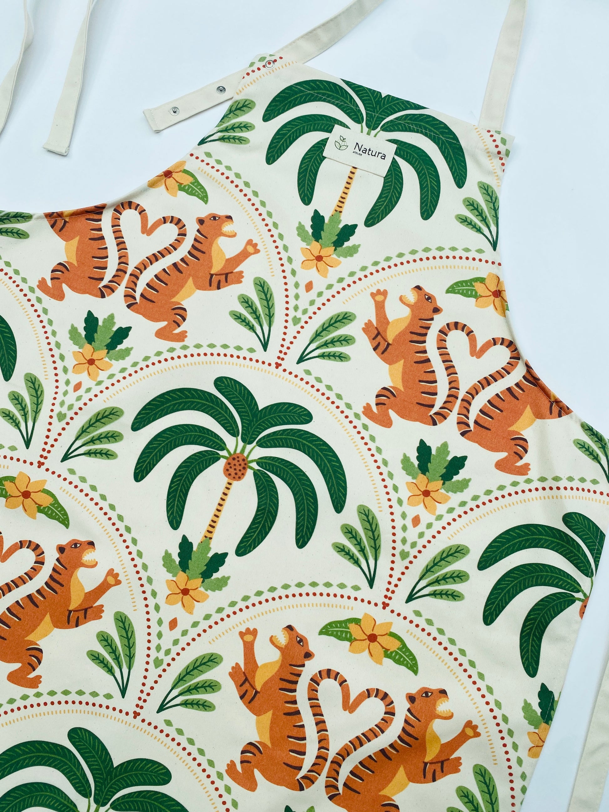 Apron with tiger and palm tree pattern on a white background