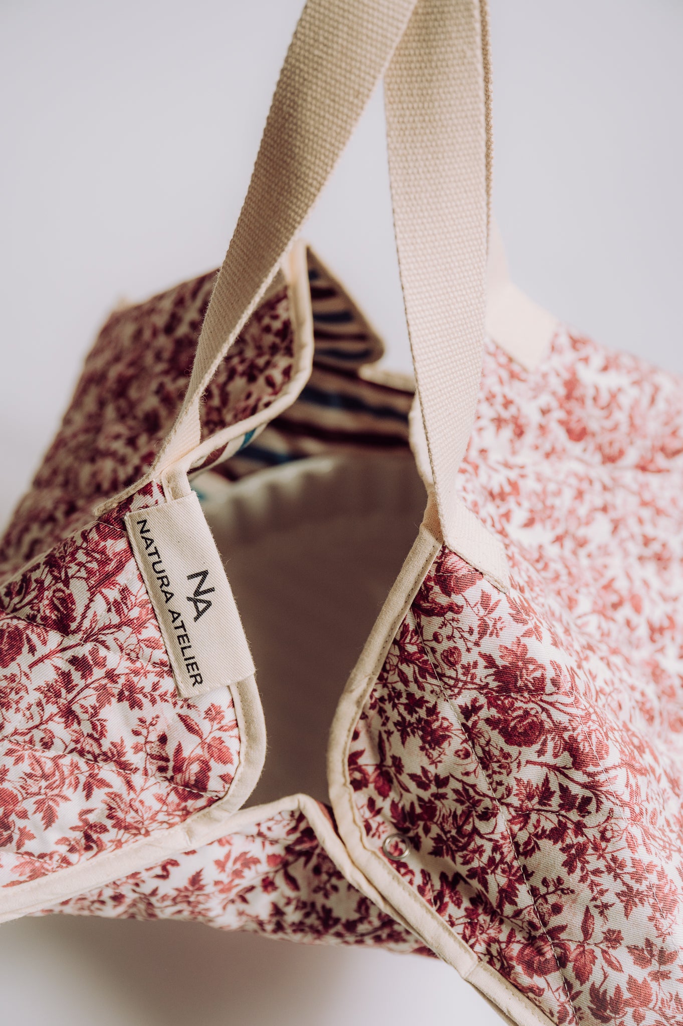 Toile de Jouy cake carrier bag with a visible NAtura Atelier brand label 