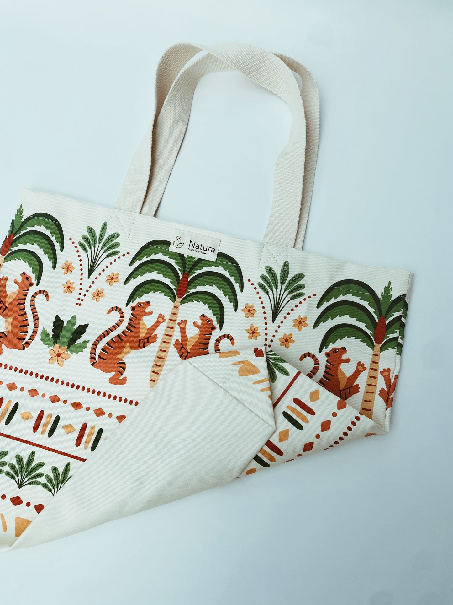 Tote bag with tiger and palm tree design on a white background