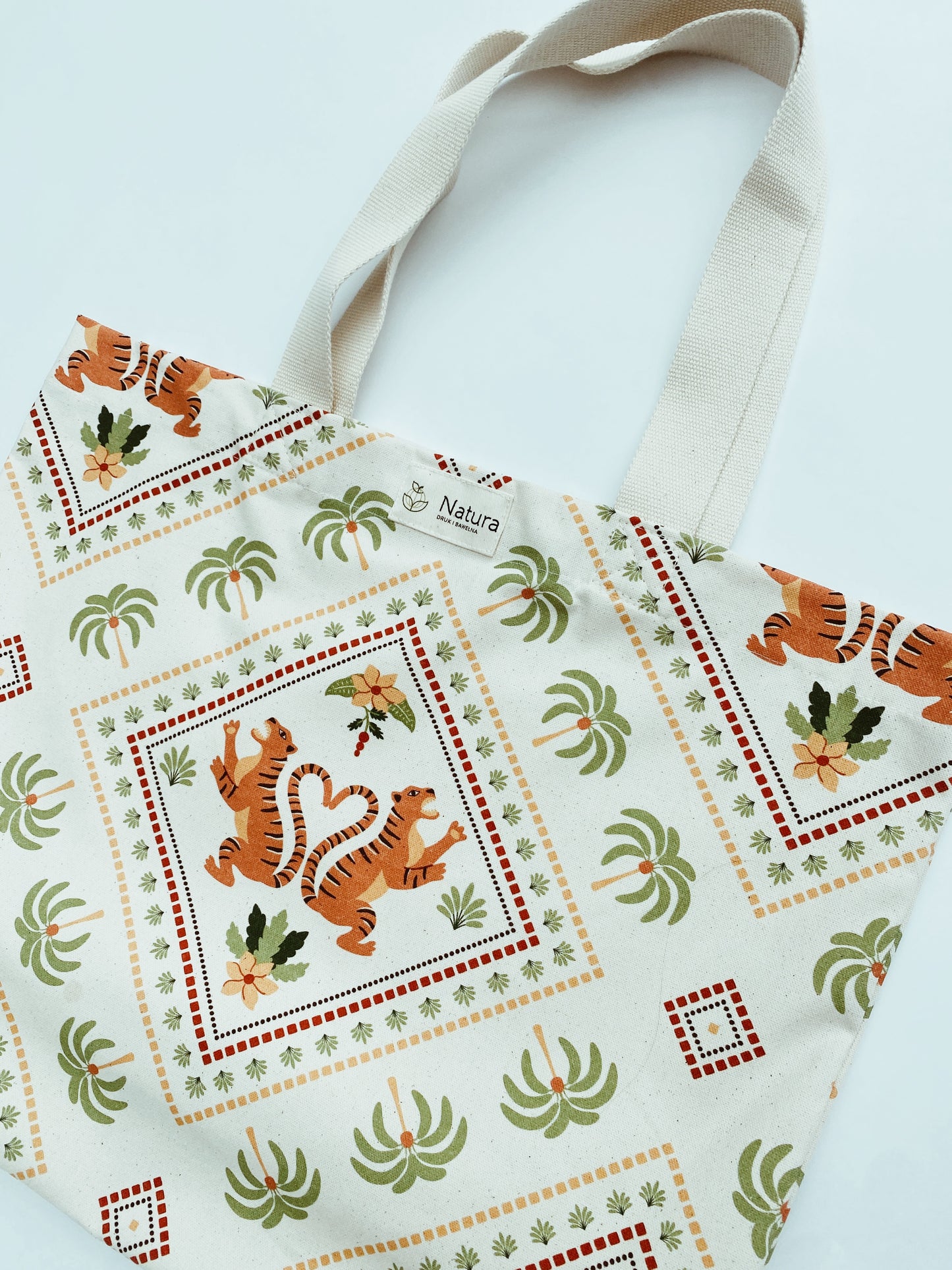Tote bag with tiger and palm tree pattern on a white background