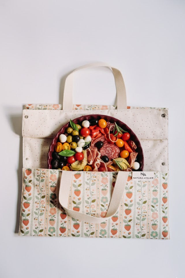 Vintage Strawberries Cake Carrier Bag with a patterned design containing a plate of food on a white background